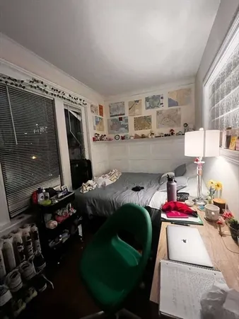 a bedroom with a bed gym equipment and view of living room