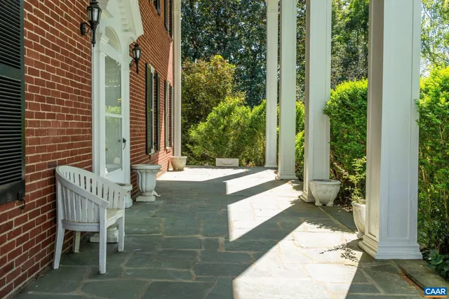 a living room with furniture large window and a fireplace