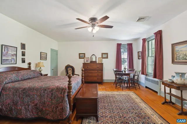 a bedroom with a large bed and a couch