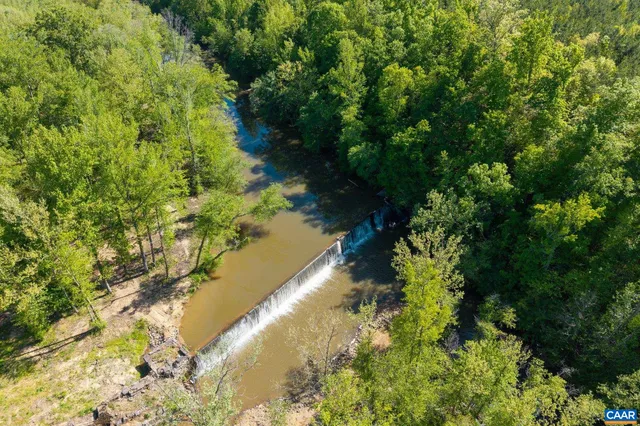 a view of a city with lush green forest