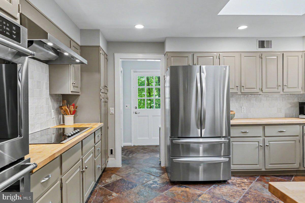 13 High Road New Hope, PA 18938 - Photo 12 of 56 a kitchen with kitchen island granite countertop a refrigerator and a sink