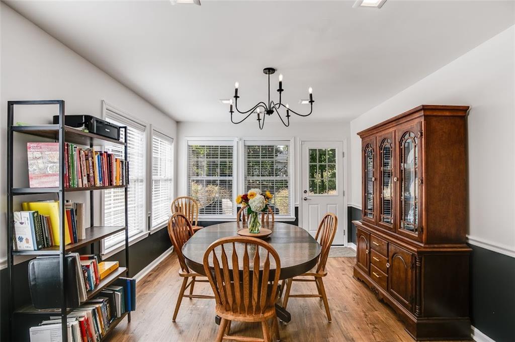 52 Castleman Road Carrollton, GA 30116 - Photo 12 of 35 a dining room with furniture a rug and wooden floor