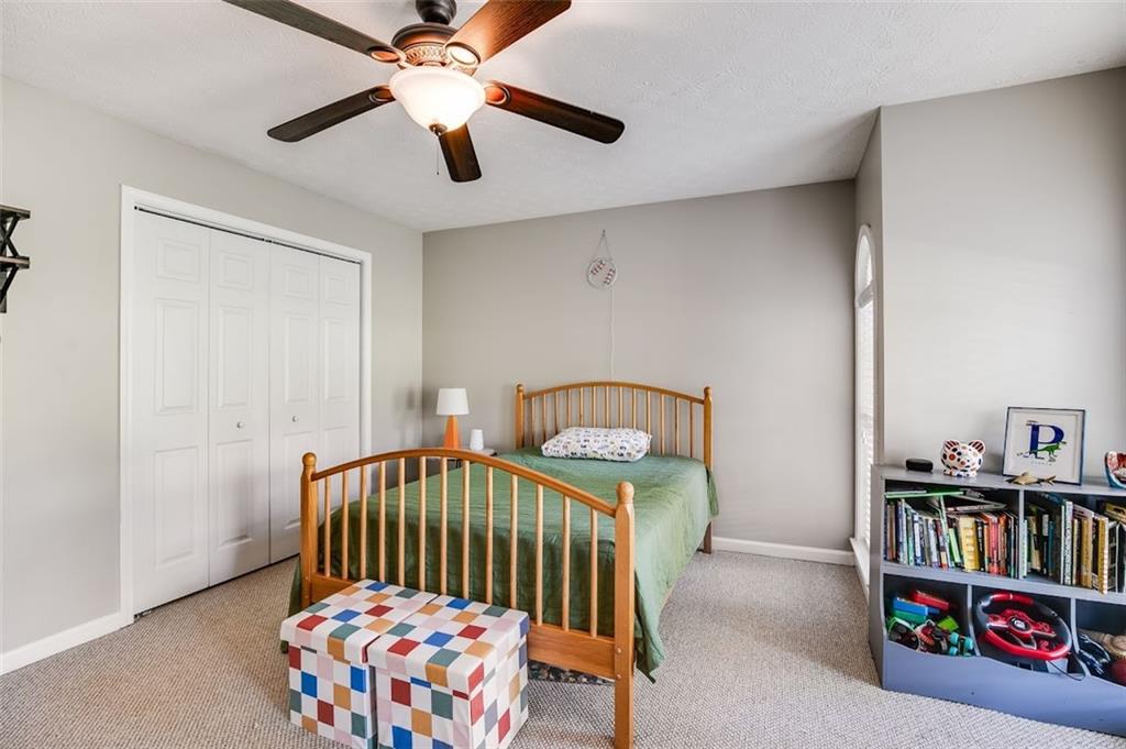 52 Castleman Road Carrollton, GA 30116 - Photo 17 of 35 a bedroom with furniture and a book shelf