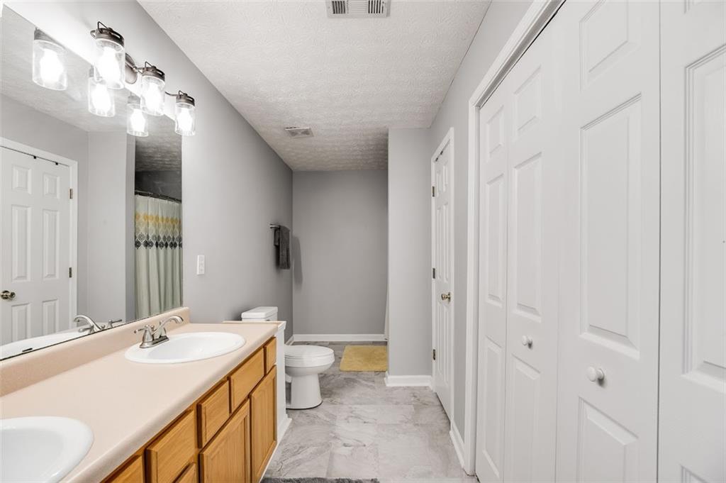 52 Castleman Road Carrollton, GA 30116 - Photo 22 of 35 a bathroom with a double vanity sink mirror and toilet