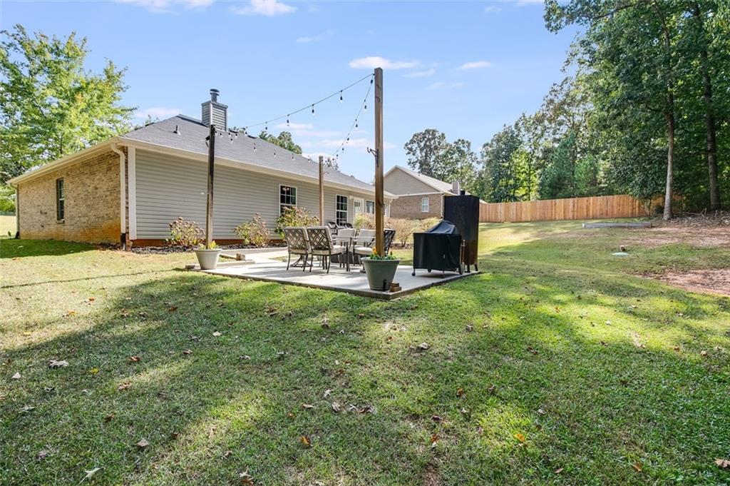 52 Castleman Road Carrollton, GA 30116 - Photo 26 of 35 a backyard of a house with table and chairs