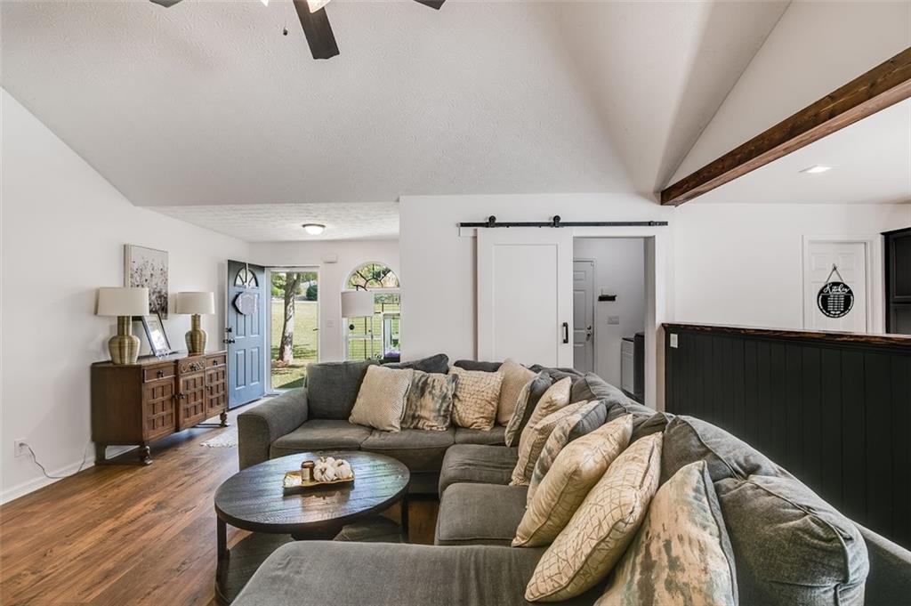 52 Castleman Road Carrollton, GA 30116 - Photo 10 of 35 a living room with furniture and a wooden floor