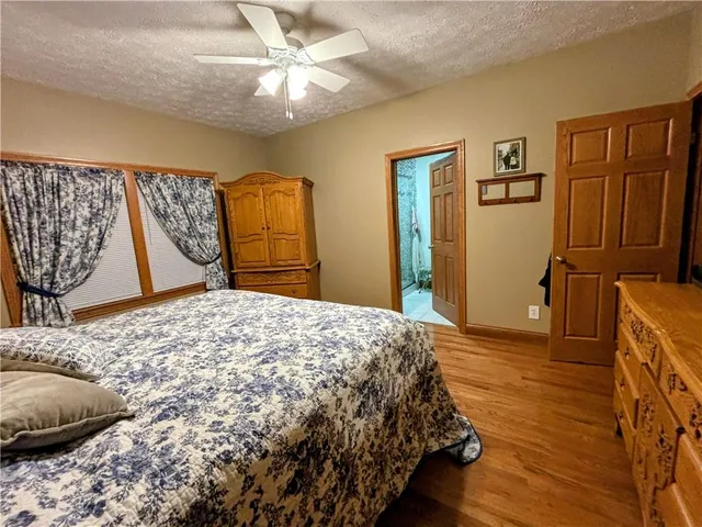 a bedroom with a bed dresser and a window
