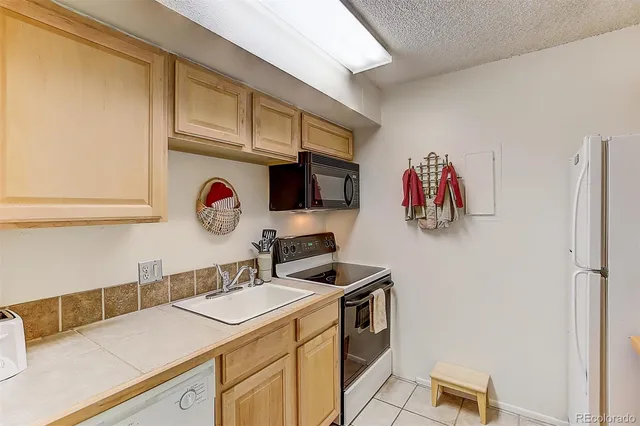 a kitchen with stainless steel appliances granite countertop a sink and a stove