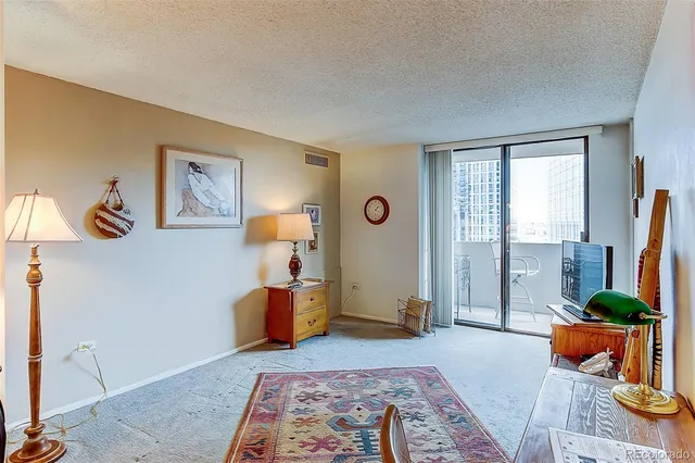 a bedroom with furniture and a large window