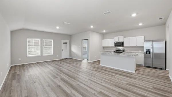 a kitchen with stainless steel appliances granite countertop a sink stove and wooden floor