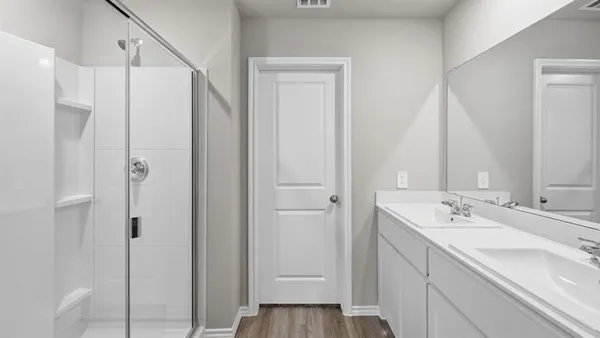 a bathroom with a shower and a glass door