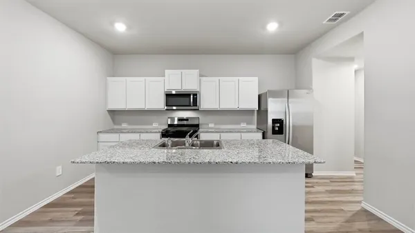 a kitchen with a sink stove and microwave