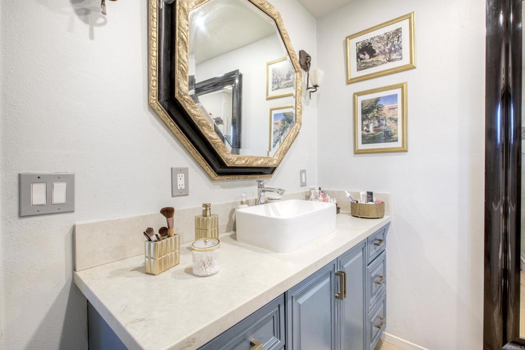 1773 Ivy Road Oceanside, CA 92054 - Photo 23 of 30 a bathroom with a sink vanity and a mirror