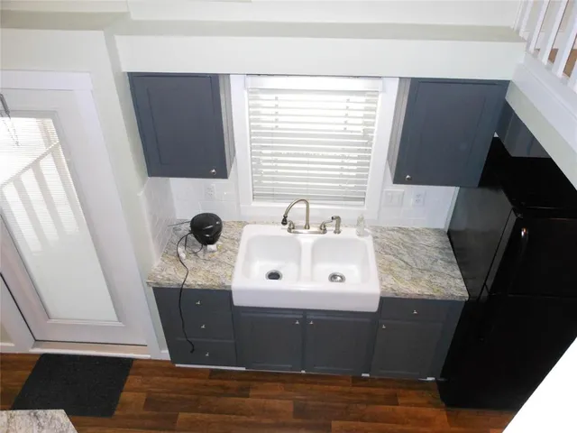 a view of a sink a mirror and cabinets