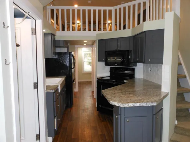 a kitchen with a sink a stove and cabinets