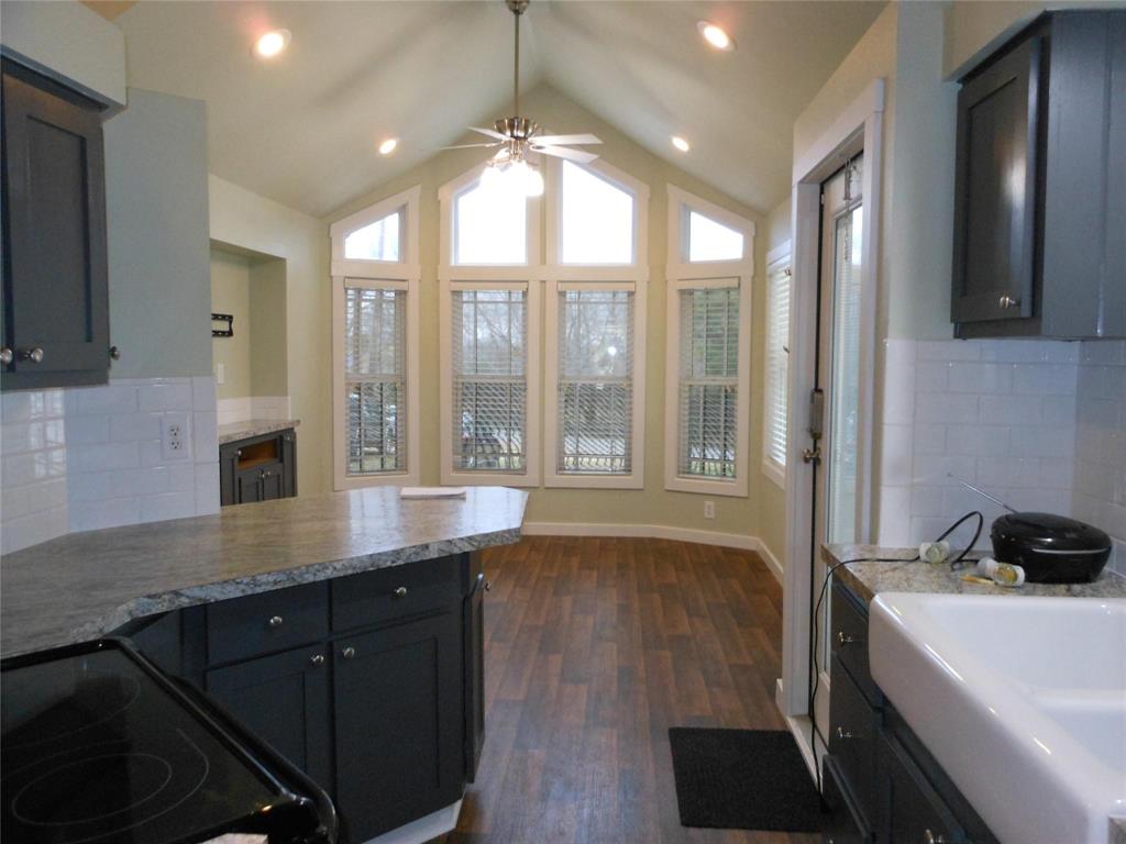 2350 East Stone Road Wylie, TX 75098 - Photo 8 of 24 a view of a kitchen with a sink wooden cabinets and a window