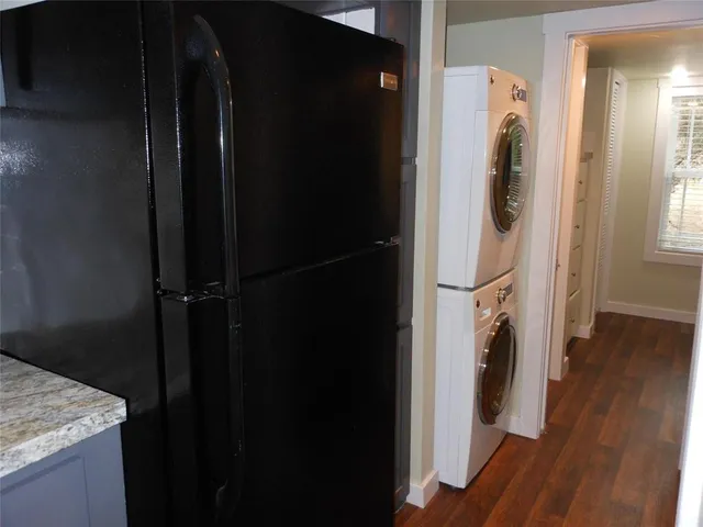 a view of walk in closet with window and wooden floor