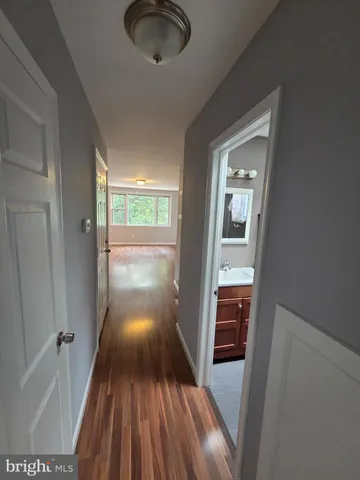 a view of a hallway view with wooden floor and staircase