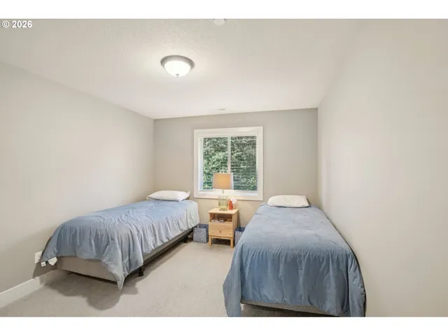 a bedroom with two beds and window