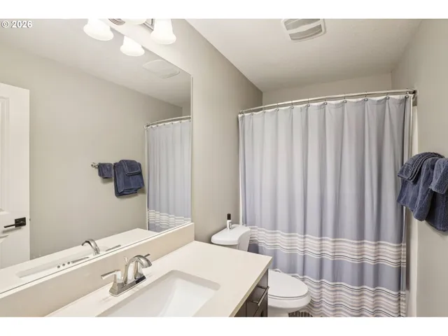 a bathroom with a sink vanity and mirror