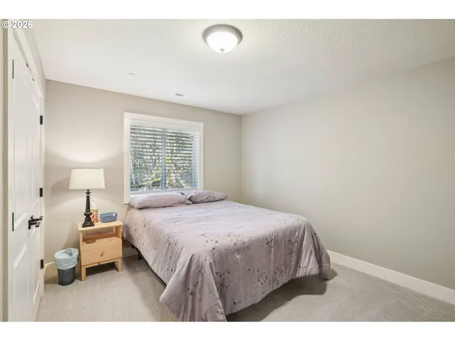a bedroom with a bed and window