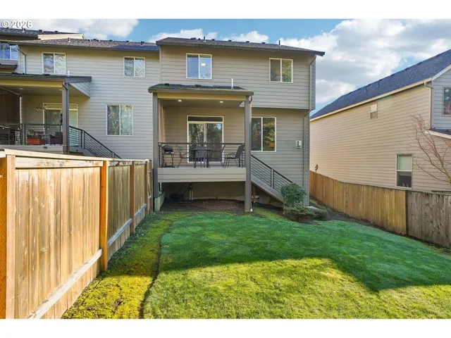 a view of a house with backyard and porch