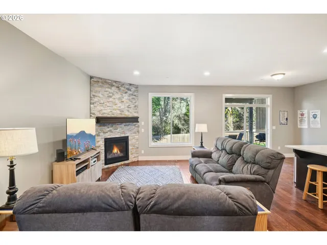 a living room with furniture large window and a fireplace