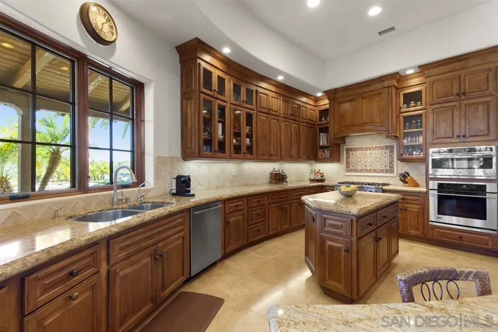 Encinitas, CA 92024 - Photo 12 of 25 a kitchen with stainless steel appliances granite countertop a stove a sink and a refrigerator