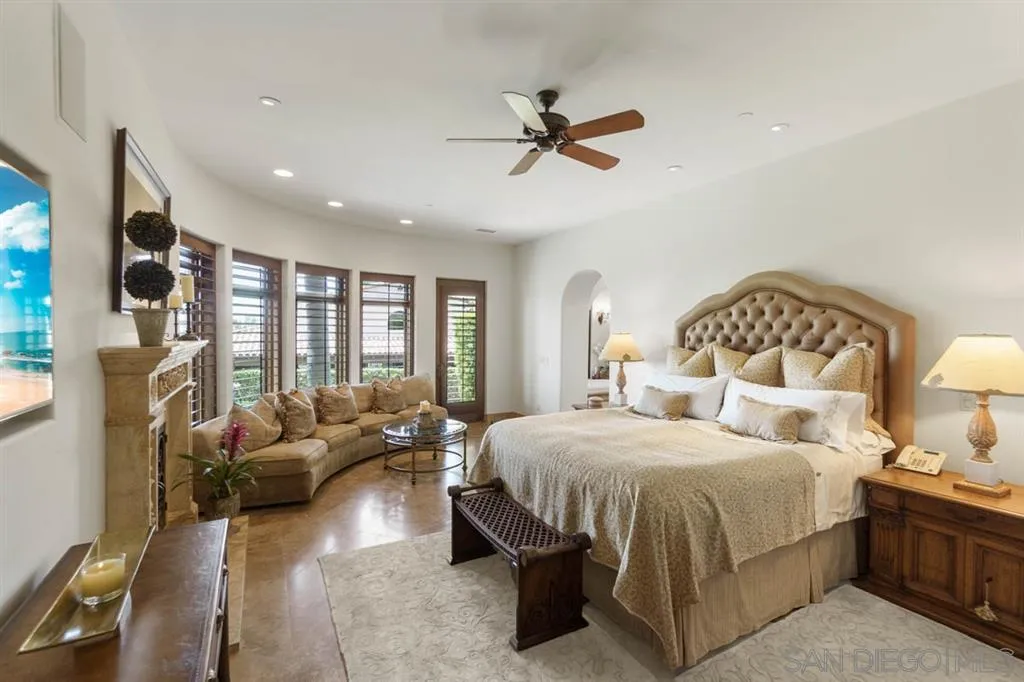 Encinitas, CA 92024 - Photo 13 of 25 a bedroom with a large bed and a chandelier