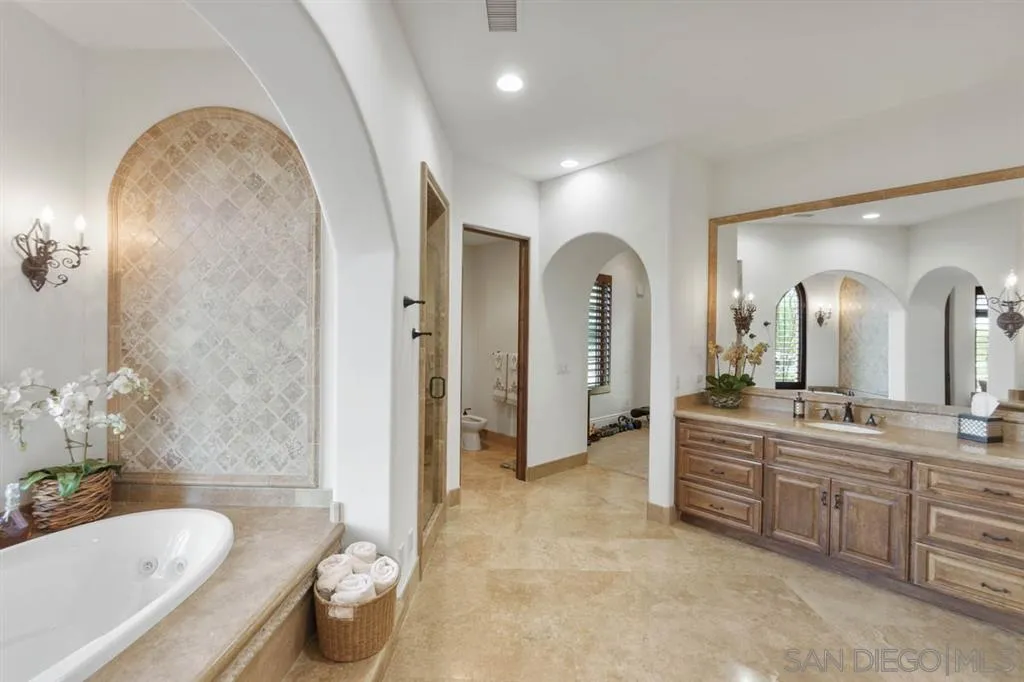 Encinitas, CA 92024 - Photo 14 of 25 a large spacious bathroom with a granite countertop tub double vanity and a glass door