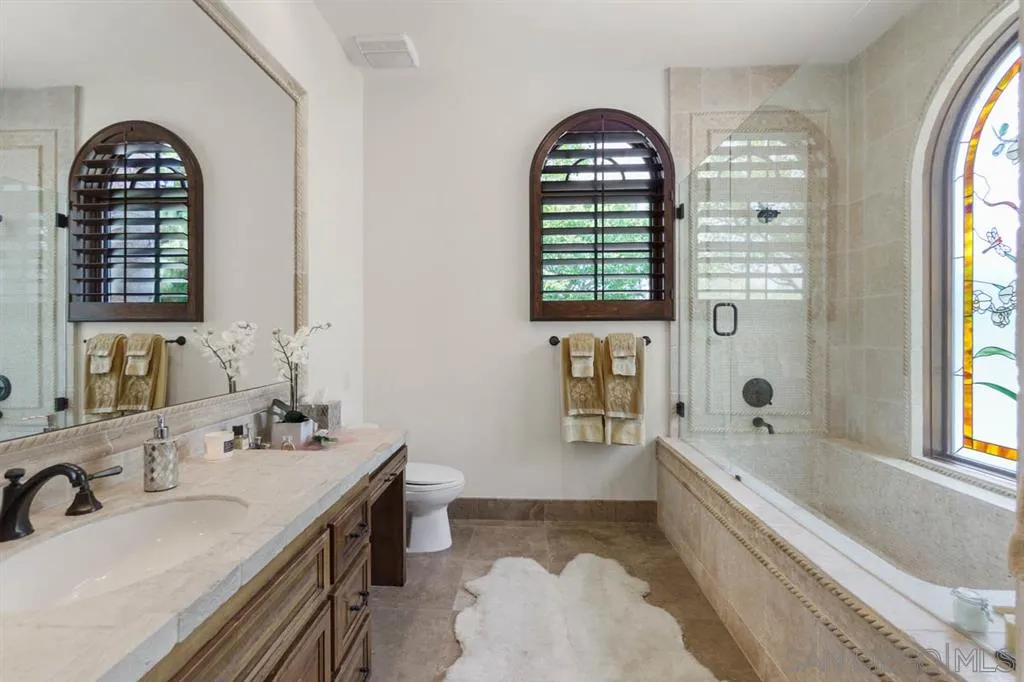 Encinitas, CA 92024 - Photo 18 of 25 a bathroom with a tub sink and mirror