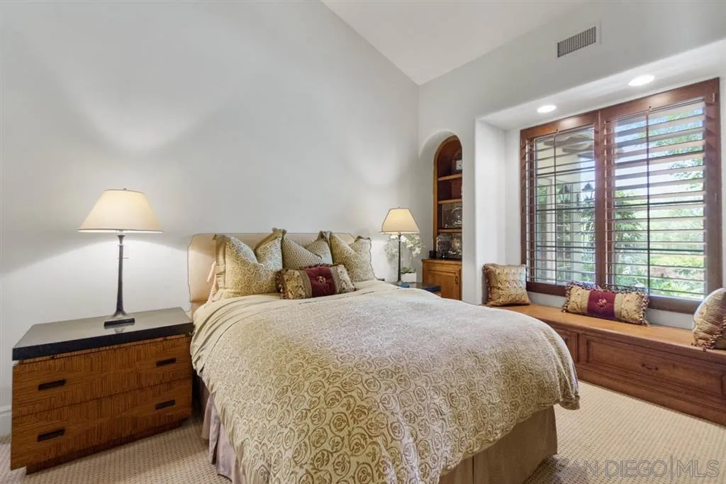 Encinitas, CA 92024 - Photo 19 of 25 a bed room with a bed and a lamp