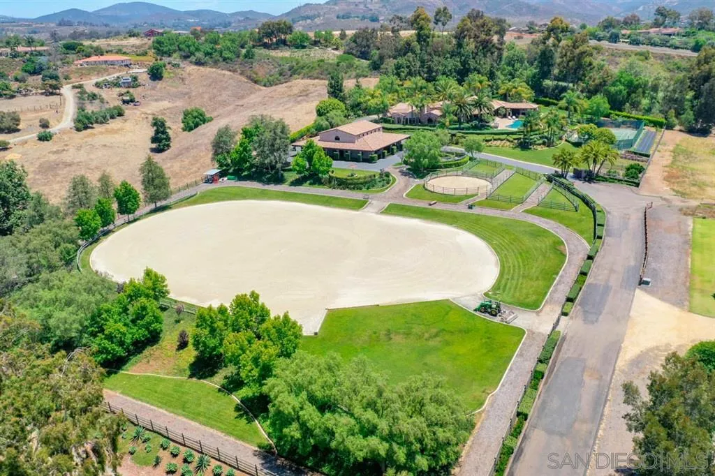 Encinitas, CA 92024 - Photo 2 of 25 an aerial view of a house with a garden and mountain view in back