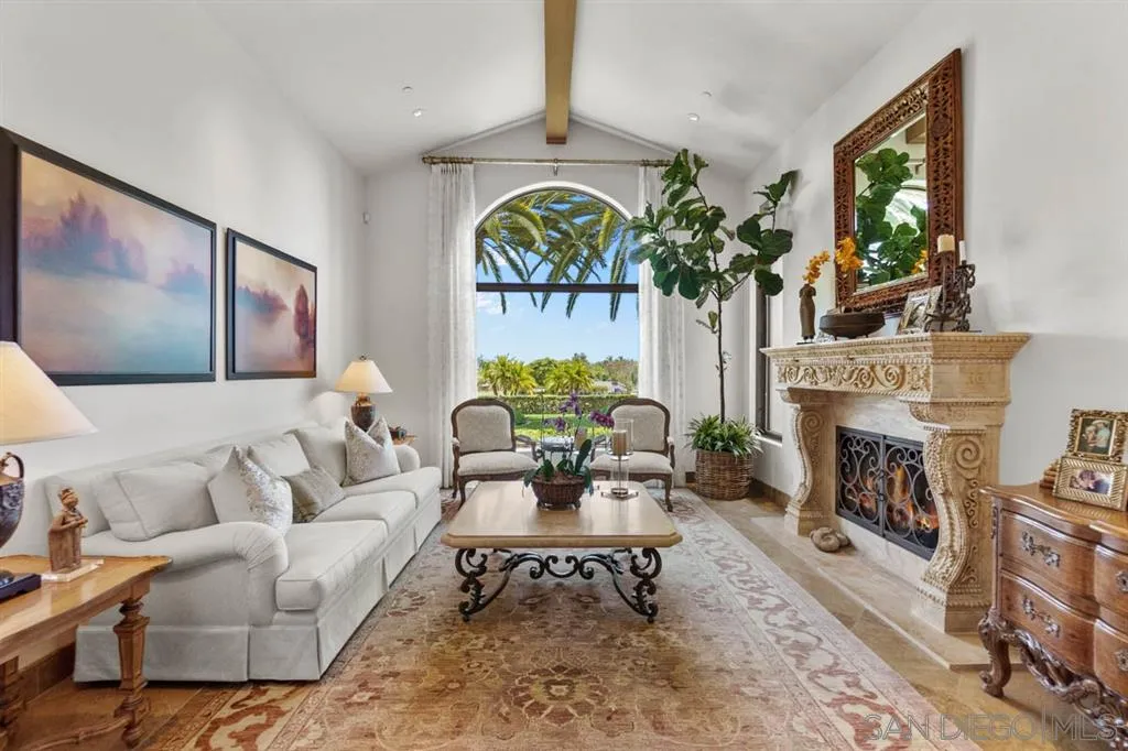 Encinitas, CA 92024 - Photo 8 of 25 a living room with furniture a fireplace and a potted plant