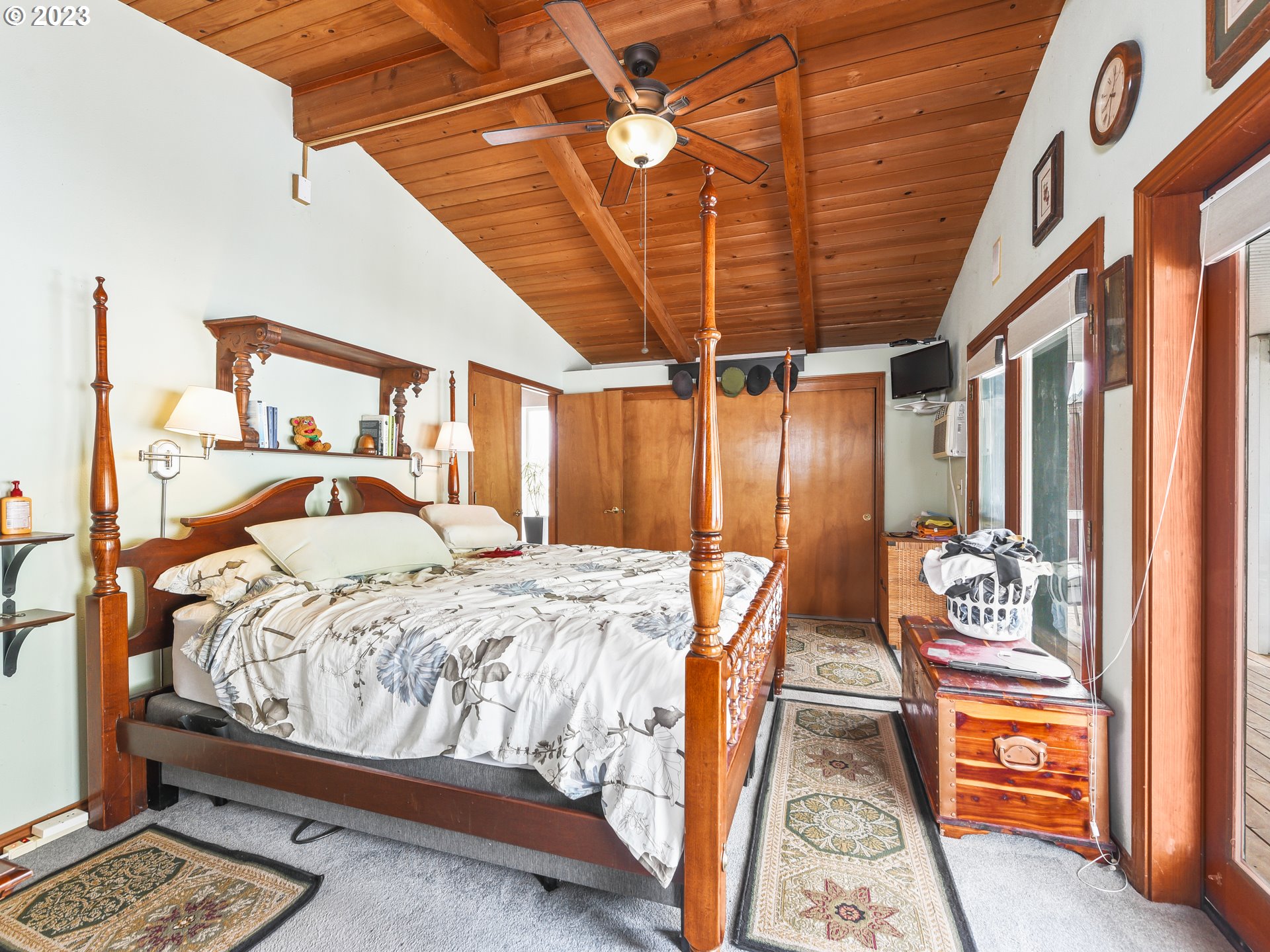 23586 Northwest St Helens Road, Unit M34 Portland, OR 97231 - Photo 10 of 20 a bedroom with a bed and a chandelier