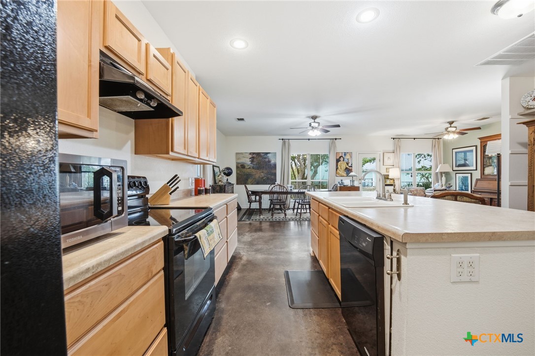 3075 Rustler Canyon Lake, TX 78133 - Photo 11 of 48 a kitchen with stainless steel appliances granite countertop a stove and a sink