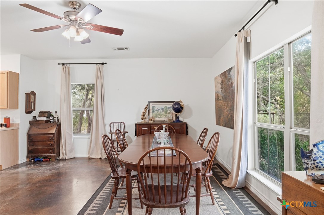 3075 Rustler Canyon Lake, TX 78133 - Photo 14 of 48 a view of a dining room with furniture window and wooden floor