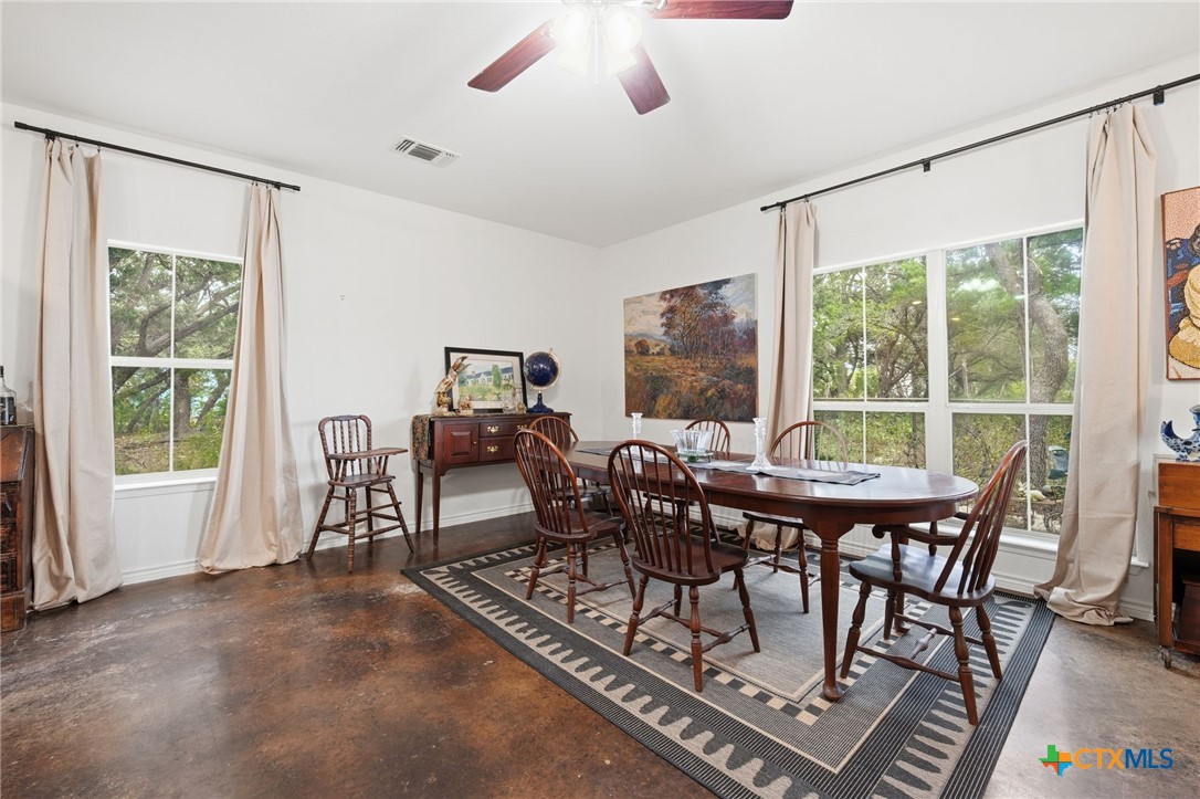 3075 Rustler Canyon Lake, TX 78133 - Photo 16 of 48 a view of a dining room with furniture window and outside view