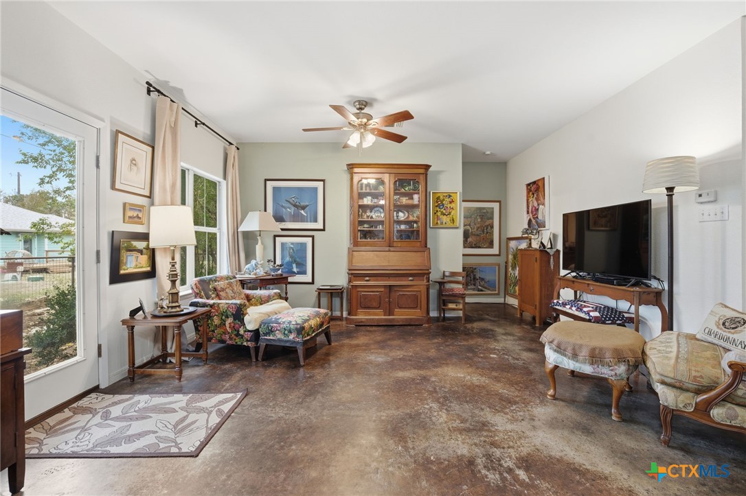 3075 Rustler Canyon Lake, TX 78133 - Photo 18 of 48 a living room with furniture a flat screen tv and large window