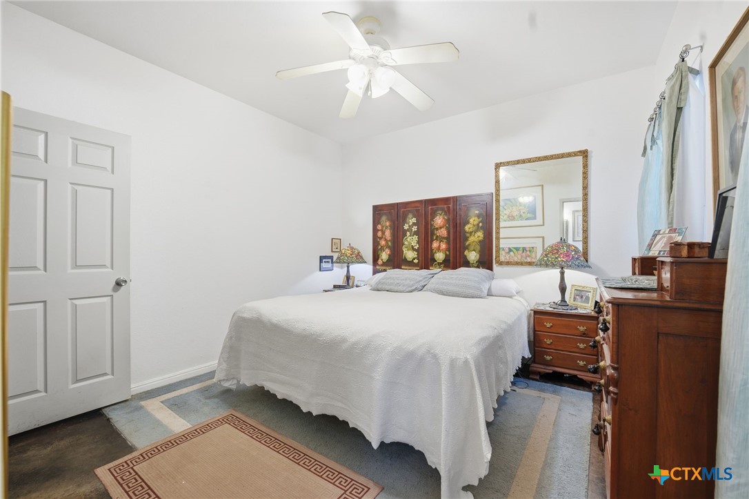 3075 Rustler Canyon Lake, TX 78133 - Photo 24 of 48 a bedroom with a bed and wooden floor