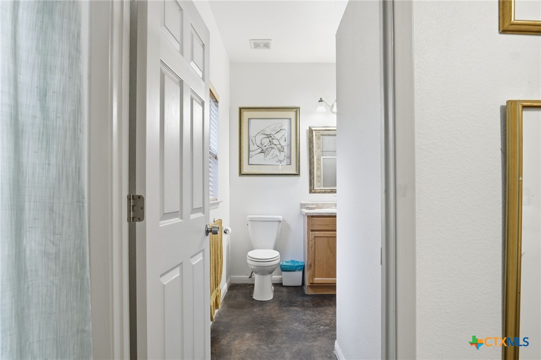 3075 Rustler Canyon Lake, TX 78133 - Photo 25 of 48 a bathroom with a toilet and a view of bathroom