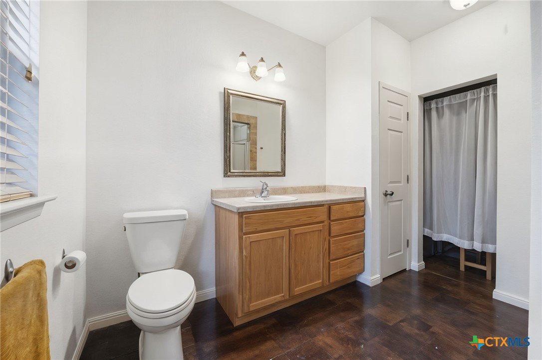 3075 Rustler Canyon Lake, TX 78133 - Photo 27 of 48 a bathroom with a toilet sink and mirror