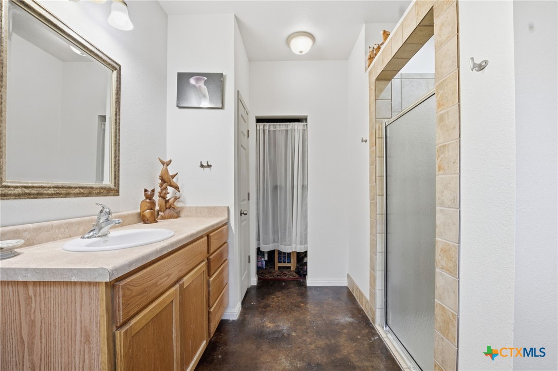 3075 Rustler Canyon Lake, TX 78133 - Photo 28 of 48 a bathroom with a double vanity sink and a mirror