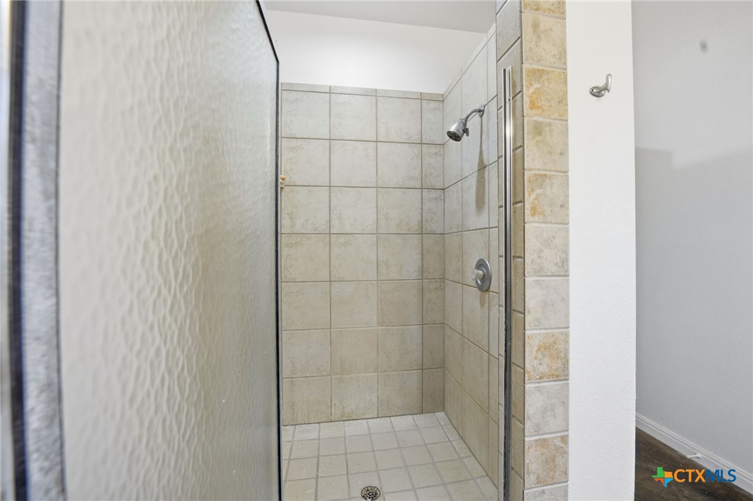 3075 Rustler Canyon Lake, TX 78133 - Photo 30 of 48 a bathroom with a shower and a glass door