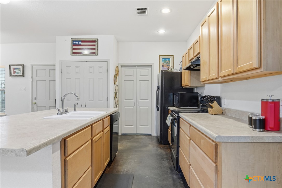 3075 Rustler Canyon Lake, TX 78133 - Photo 9 of 48 a kitchen with a sink stove and refrigerator