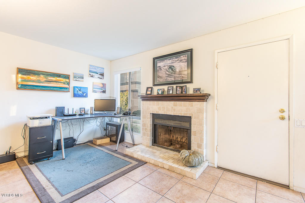 5149 Perkins Road Oxnard, CA 93033 - Photo 14 of 40 a living room with furniture a flat screen tv and a fireplace