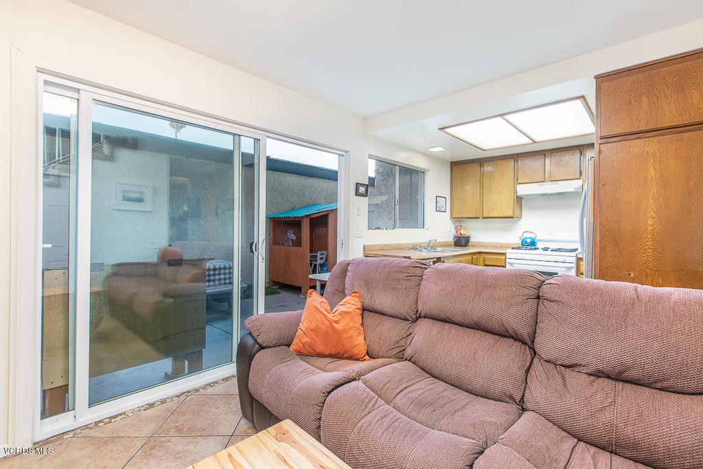 5149 Perkins Road Oxnard, CA 93033 - Photo 22 of 40 a living room with furniture and a glass door