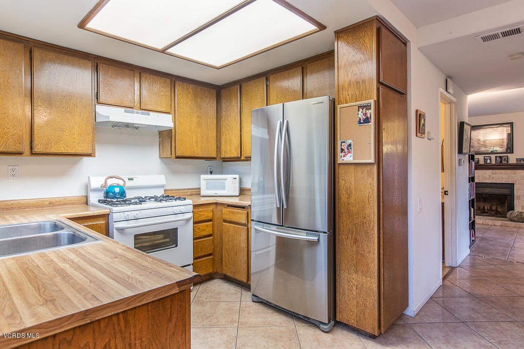 5149 Perkins Road Oxnard, CA 93033 - Photo 24 of 40 a kitchen with stainless steel appliances granite countertop a refrigerator a sink and dishwasher