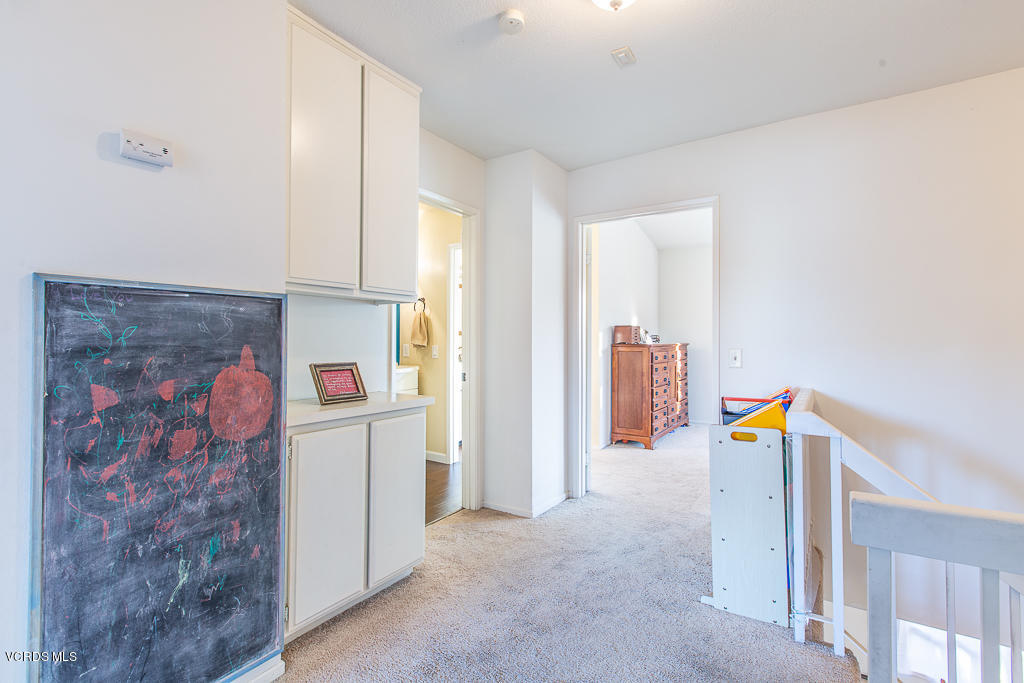 5149 Perkins Road Oxnard, CA 93033 - Photo 28 of 40 a view of a hallway with two cabinet door