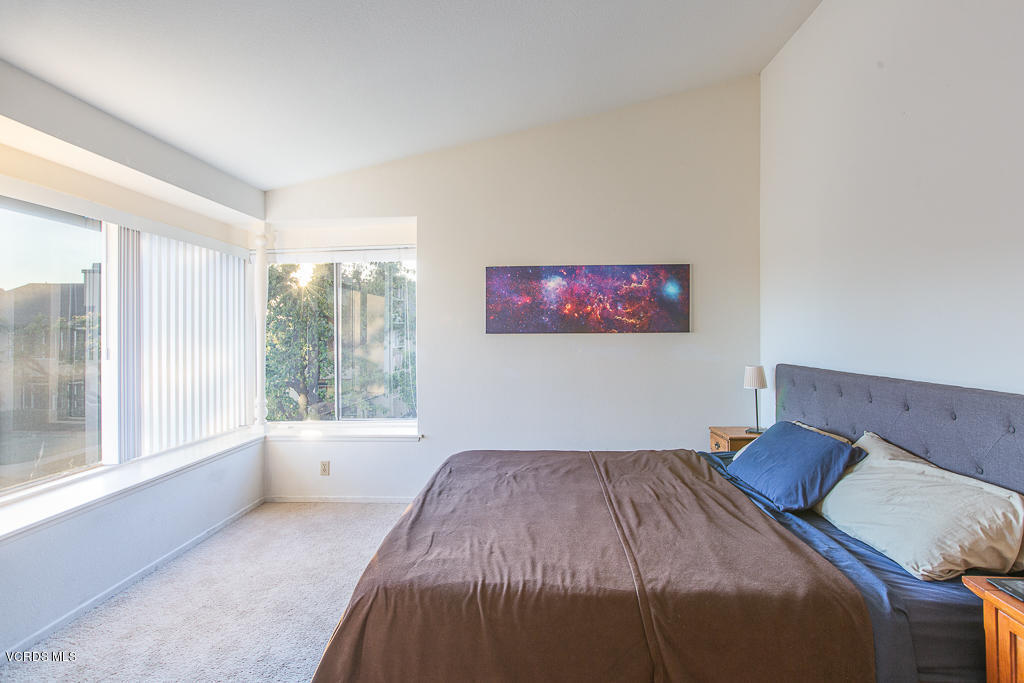 5149 Perkins Road Oxnard, CA 93033 - Photo 35 of 40 a bedroom with a bed and a large window